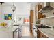 Modern kitchen boasts a stylish island, stainless steel appliances, and abundant natural light at 3363 W 32Nd Ave, Denver, CO 80211