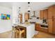 Open kitchen features a large island with seating, pendant lighting, and modern appliances for cooking and entertaining at 3363 W 32Nd Ave, Denver, CO 80211