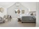 Spacious bedroom with sloped ceiling, carpeted floor, sitting area, and ambient light at 3363 W 32Nd Ave, Denver, CO 80211