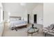 Bright main bedroom with neutral decor, tray ceiling, and an oval glass coffee table at 3363 W 32Nd Ave, Denver, CO 80211