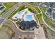 Aerial view of the community pool, clubhouse, and surrounding green spaces in a Primary planned community at 7137 S Vandriver Way, Aurora, CO 80016