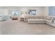 Spacious finished basement with large sectional sofa and playroom area with natural light from 2 windows at 7137 S Vandriver Way, Aurora, CO 80016