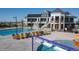 Community clubhouse and pool with colorful lounge chairs and splashpad, perfect for Gathering fun at 7137 S Vandriver Way, Aurora, CO 80016