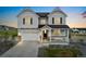 Charming two-story home featuring a spacious two-car garage, inviting front porch, and professionally landscaped front yard at 7137 S Vandriver Way, Aurora, CO 80016