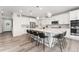 Modern kitchen with large island, stainless steel appliances, and stylish barstool seating for casual dining experiences at 7137 S Vandriver Way, Aurora, CO 80016
