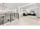 Spacious loft featuring a cozy seating area, neutral carpet, and a modern railing at 7137 S Vandriver Way, Aurora, CO 80016