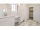 Bathroom with double vanity, marble-look floors, and a walk-in shower at 4823 Astor Pl, Brighton, CO 80601
