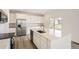 Bright kitchen with white cabinets, stainless steel appliances, and an island with a sink at 4823 Astor Pl, Brighton, CO 80601
