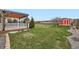 Lush backyard with a well-maintained lawn and a cozy deck, ideal for outdoor enjoyment at 11121 W 107Th Pl, Westminster, CO 80021