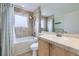 Bright bathroom featuring tile accents, a tub, and a shower head at 11121 W 107Th Pl, Westminster, CO 80021