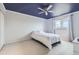 Serene bedroom with a blue ceiling, ceiling fan, and a large window offering natural light at 11121 W 107Th Pl, Westminster, CO 80021