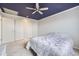 Spacious bedroom with a striking blue ceiling, ceiling fan, and ample closet space at 11121 W 107Th Pl, Westminster, CO 80021