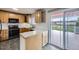 Well-lit kitchen with wood cabinets, black appliances, and access to an outdoor deck at 11121 W 107Th Pl, Westminster, CO 80021