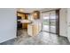 Modern kitchen with wood cabinets, black appliances, and a sliding door to the backyard deck at 11121 W 107Th Pl, Westminster, CO 80021