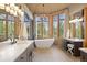 Bathroom showcasing a soaking tub, double vanities, and many windows with natural light at 786 International Isle Dr, Castle Rock, CO 80108