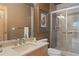 Bathroom featuring shower with glass door, modern sink, vanity, and decorative floral artwork at 786 International Isle Dr, Castle Rock, CO 80108