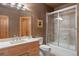 Warm-toned bathroom with shower-tub, wooden vanity, and framed mirror at 786 International Isle Dr, Castle Rock, CO 80108