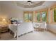 Bedroom with a white bed, multiple windows with views, and a desk area for work or study at 786 International Isle Dr, Castle Rock, CO 80108