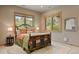 Bedroom with a stylish bed frame, two windows, and lamps on either side of the bed at 786 International Isle Dr, Castle Rock, CO 80108