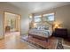 Bedroom featuring hardwood floors, a decorative rug, and large windows, providing an abundance of natural light at 786 International Isle Dr, Castle Rock, CO 80108
