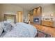 Bedroom featuring a fireplace, wood floors, a decorative rug, and views into the rest of the home at 786 International Isle Dr, Castle Rock, CO 80108