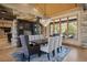Elegant dining room featuring a modern chandelier, stone accent wall, and comfortable seating at 786 International Isle Dr, Castle Rock, CO 80108