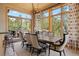 Dining room featuring a large table, statement chandelier, and large windows overlooking the lush landscape at 786 International Isle Dr, Castle Rock, CO 80108