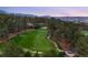 Picturesque golf course view surrounded by towering pine trees with a cart path and beautiful homes in the distance at 786 International Isle Dr, Castle Rock, CO 80108