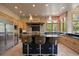 Gourmet kitchen featuring a dark island, stainless steel appliances, and stone backsplash at 786 International Isle Dr, Castle Rock, CO 80108