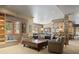 Spacious living room with fireplace, built-in bar, comfortable seating, and large windows at 786 International Isle Dr, Castle Rock, CO 80108