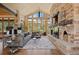 Inviting living room boasting vaulted ceilings, stone fireplace, and large windows with outdoor views at 786 International Isle Dr, Castle Rock, CO 80108