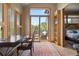 Office featuring wood floors, a desk, and large windows with sliding glass doors leading to a balcony at 786 International Isle Dr, Castle Rock, CO 80108