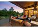 Covered patio with comfortable seating surrounding a fire pit, perfect for outdoor entertaining and relaxation at 786 International Isle Dr, Castle Rock, CO 80108