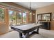 Bright recreation room with pool table and large glass doors leading to the patio and yard at 786 International Isle Dr, Castle Rock, CO 80108