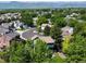Aerial neighborhood view with lush trees, well-maintained homes, and mountain views at 8296 S Reed St, Littleton, CO 80128
