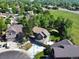 Expansive aerial view of a suburban neighborhood featuring well-manicured lawns and mature trees at 8296 S Reed St, Littleton, CO 80128