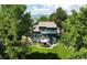 Lovely two-story home with a well-maintained lawn, mature trees, and a deck, creating a serene backyard retreat at 8296 S Reed St, Littleton, CO 80128