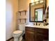 Bathroom vanity with modern faucet, mirror, and built-in shelving at 8296 S Reed St, Littleton, CO 80128