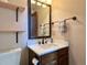 Bathroom featuring a modern vanity, mirror and decorative fixtures at 8296 S Reed St, Littleton, CO 80128