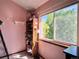 A cozy bedroom nook, illuminated by natural light, with a shelf of plush toys, a decorative fan, and unique floor lamp at 8296 S Reed St, Littleton, CO 80128