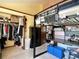 Bedroom with a lofted bed above a study area, walk-in closet, a chest of drawers, and blue storage ottomans at 8296 S Reed St, Littleton, CO 80128