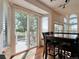 Bright dining area with sliding glass doors leading to outdoor patio and deck at 8296 S Reed St, Littleton, CO 80128