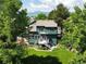 Charming two-story home featuring a lush green lawn, deck and views of the mountains at 8296 S Reed St, Littleton, CO 80128