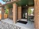 Inviting front porch with brick pillars, neutral colors, and a cozy seating area at 8296 S Reed St, Littleton, CO 80128