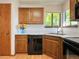 Bright corner kitchen with ample counter space, oak cabinets, and modern appliances at 8296 S Reed St, Littleton, CO 80128