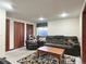Comfortable living room with a cozy couch and decorative rug, perfect for relaxing and entertaining guests at 8296 S Reed St, Littleton, CO 80128