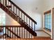 Carpeted staircase with dark wood railing, leading to the upper level of the house with a bright window at 8296 S Reed St, Littleton, CO 80128