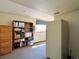 Spacious storage room featuring ample shelving, a window for natural light, and a large fridge at 8296 S Reed St, Littleton, CO 80128