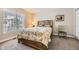 Bedroom featuring a bed with a floral quilt, and a large window at 4396 S Quail Way, Littleton, CO 80127