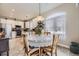 Dining area with table set with flowers and view of kitchen at 4396 S Quail Way, Littleton, CO 80127